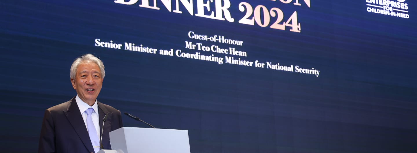 Mr. Teo Chee Hean speaks at 'Dinner 2024' event. He wears a suit at a podium.